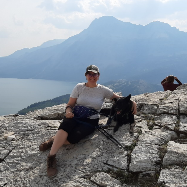 Brittany hiking in the mountains with her pup, Mickey